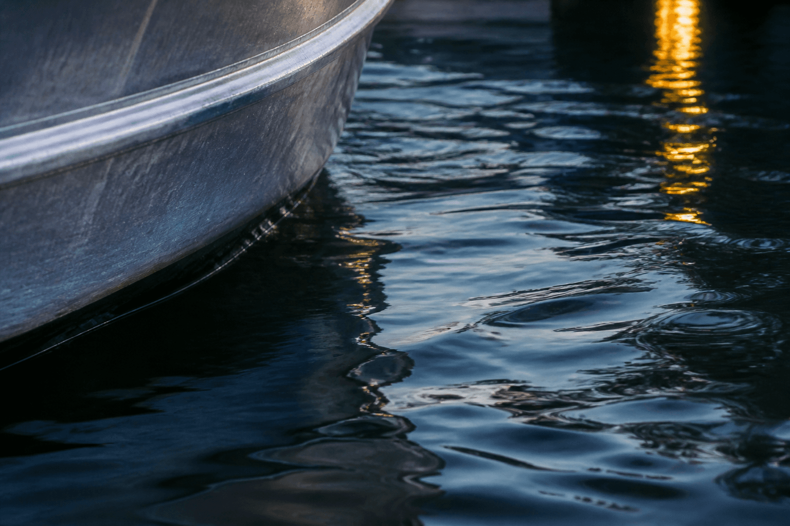 Aluminum hull meeting dark river water